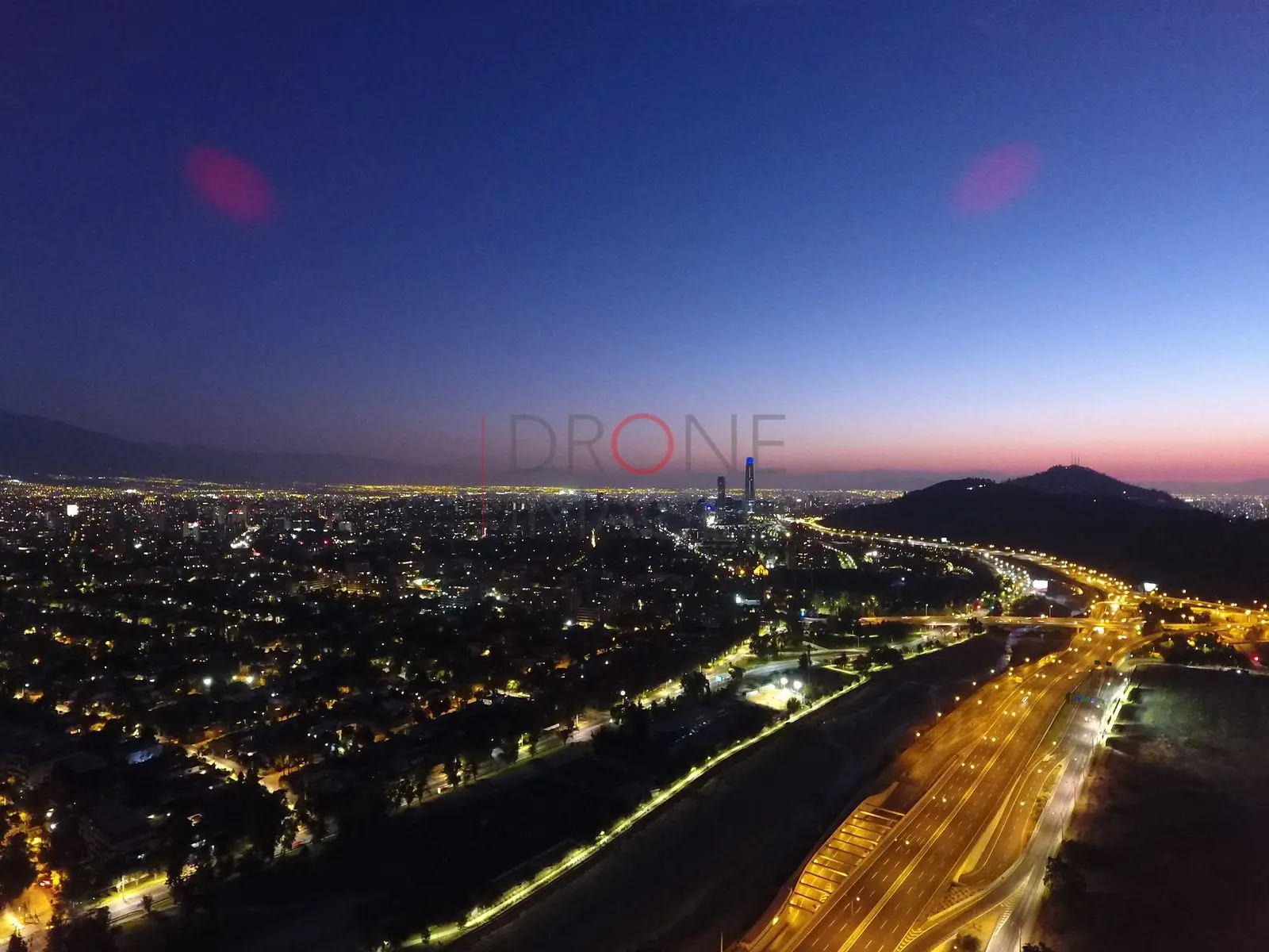 Cerro y ciudad iluminada al anochecer, Vitacura — Santiago, Chile
