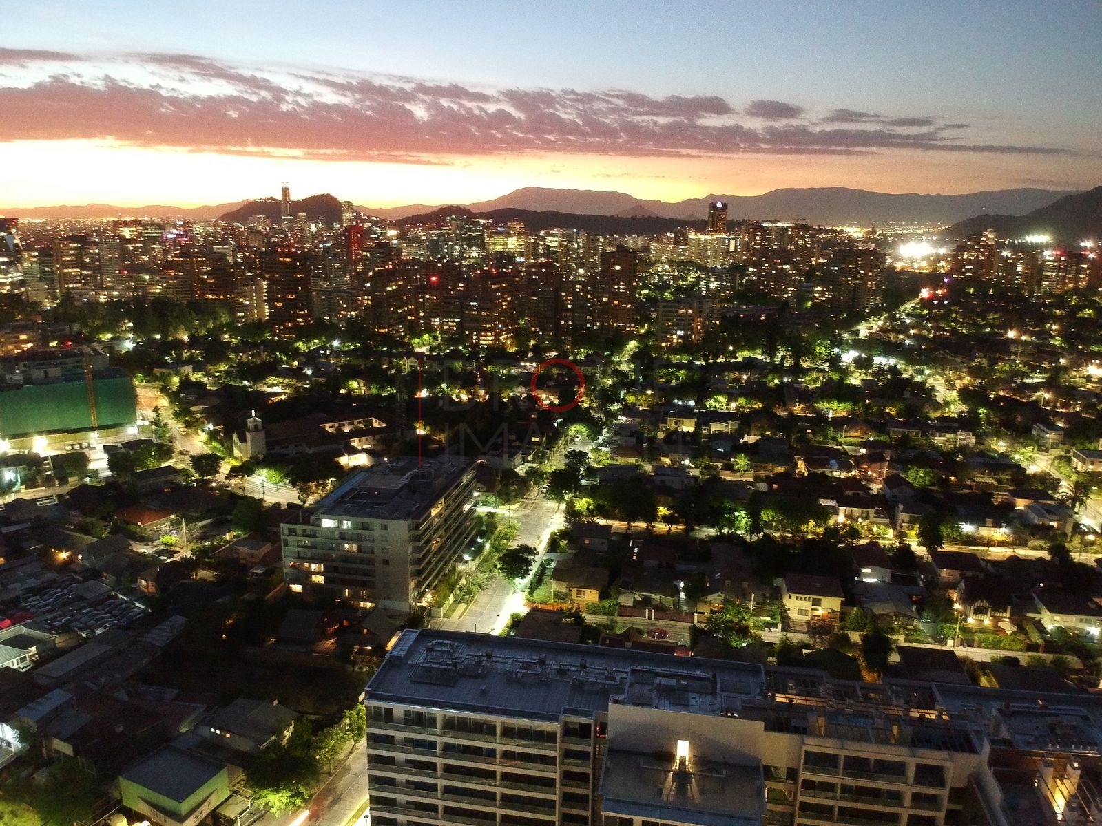 Ciudad y cielo naranja al anochecer, Las Condes